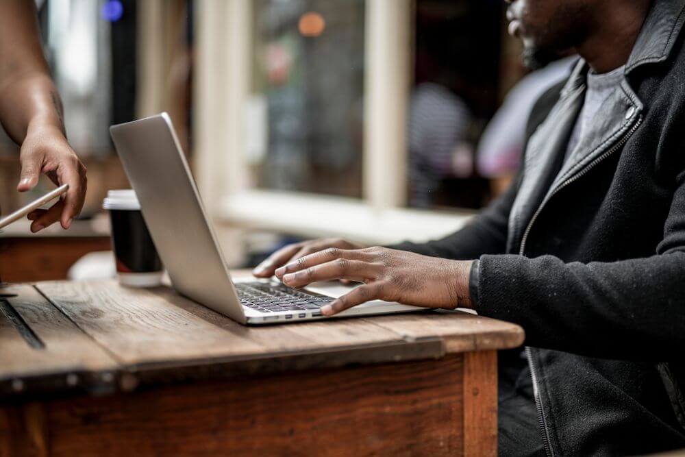 Man typing on laptop at desk