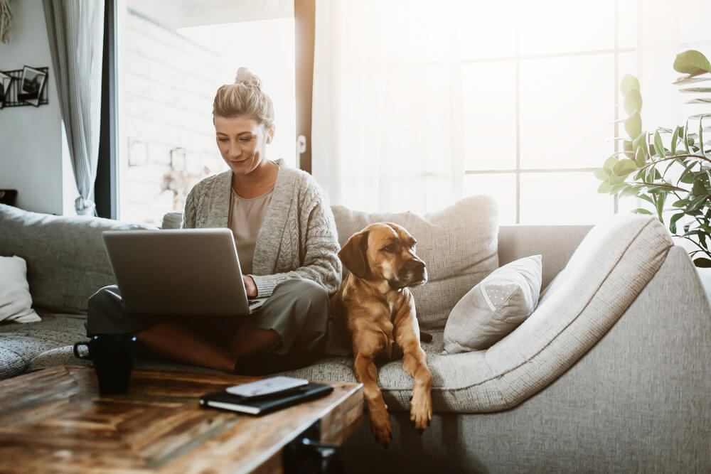 Woman working from home with dog