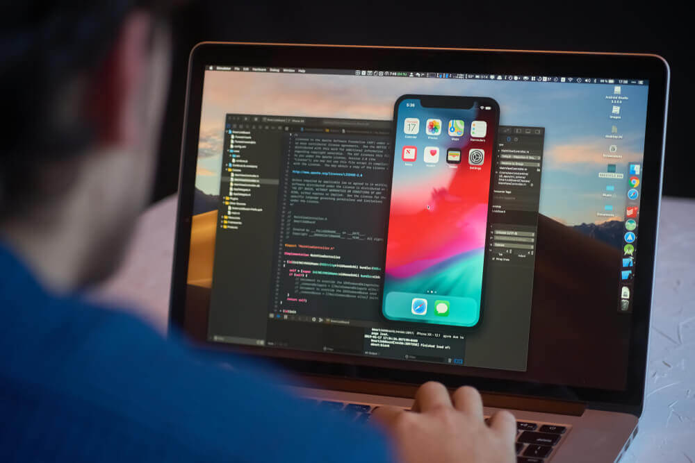 Man writing app code on computer