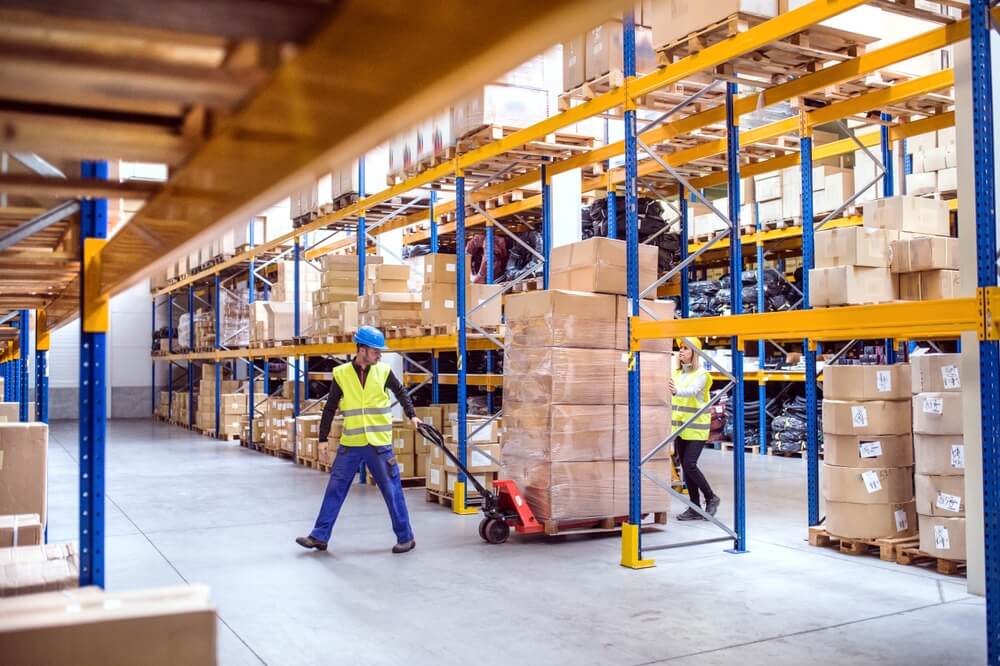 Warehouse space with man wheeling boxes
