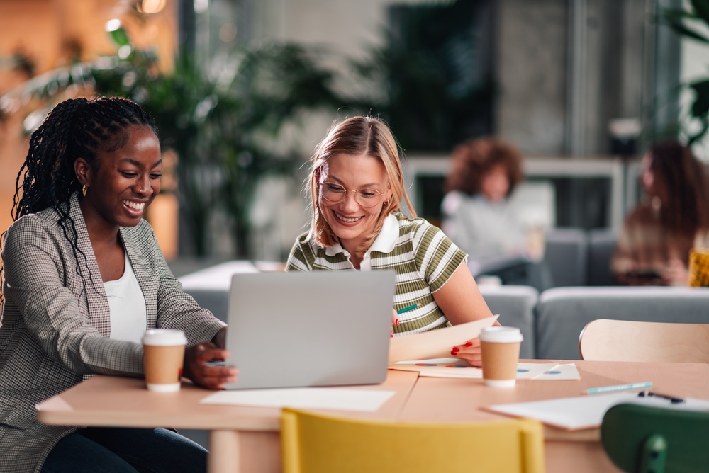 Women in coworking space using AI productivity tools