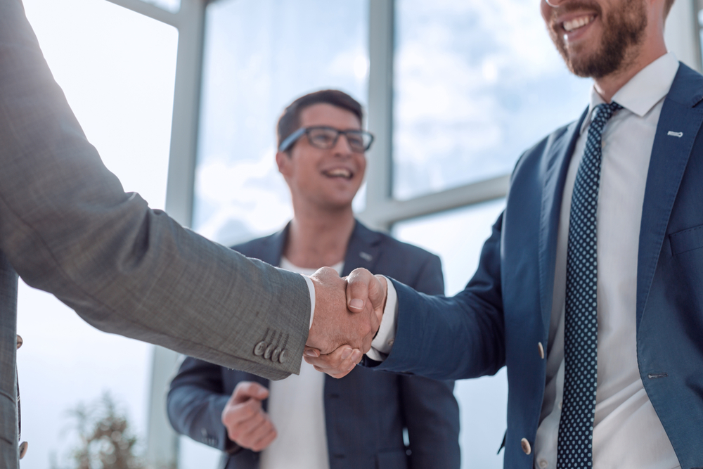 Professionals from the Northridge business community shaking hands on deal