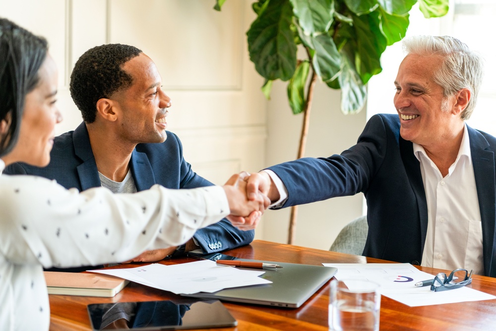 Professionals in a Northridge meeting room shaking hands