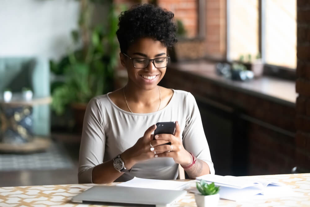 Woman using phone at desk