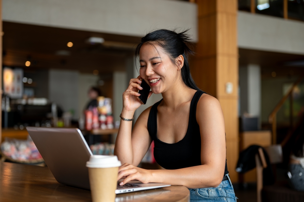 Woman working at coffee shop with VPN on her laptop