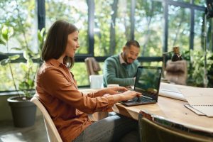 Woman working around others in coworking space