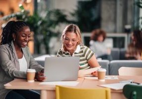 Women in coworking space using AI productivity tools