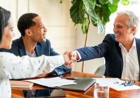 Professionals in a Northridge meeting room shaking hands