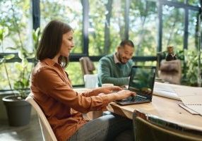 Woman working around others in coworking space